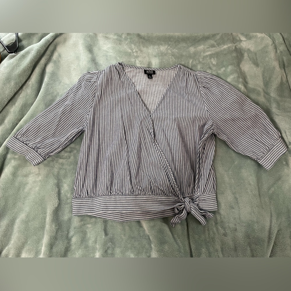 Striped white and blue blouse. Quarter lengths sleeves. Wrap in front with tie